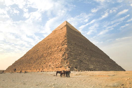 Great Pyramid of Giza at golden hour with dramatic sky