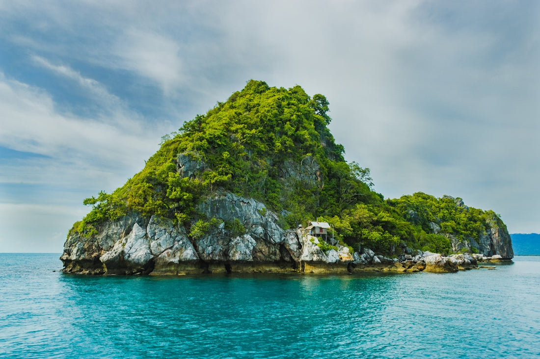Tropical island with ancient stone ruins emerging from turquoise water